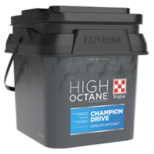 Purina High Octane Champion Drive Topdress. Grey plastic pail with lid. Features a blue product label.